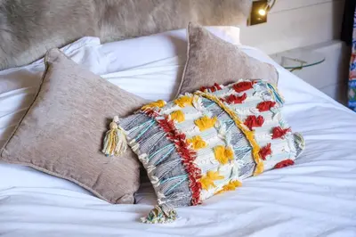 a bed with two pillows on top of it at Mission Lodge in Thorpeness