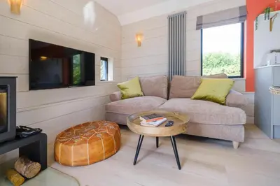 a living room with a couch and a table at Mission Lodge in Thorpeness