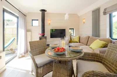 a living room with a couch and a table at Mission Lodge in Thorpeness