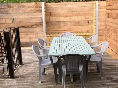 a green table and chairs on a patio at The Pink House in Felixstowe