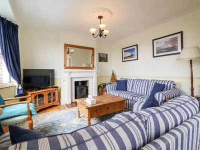 a living room with two couches and a tv at The Pink House in Felixstowe