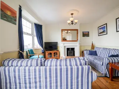 a living room with two couches and a tv at The Pink House in Felixstowe
