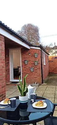 a table with two plates of food on it at Suffolk Cosy Corner with free parking, 10min walking to town centre in Bury Saint Edmunds