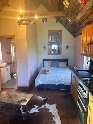 a bedroom with a bed in the middle of it at Lake View Lodges The Melford in Long Melford