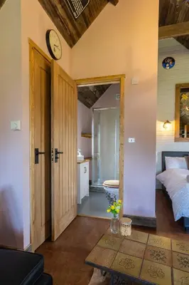 a bedroom with a bed and a clock on the wall at Lake View Lodges The Melford in Long Melford