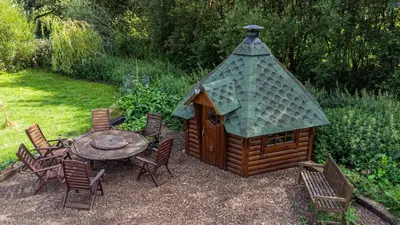 a gazebo with a table and chairs around it at Lake View Lodges The Melford in Long Melford