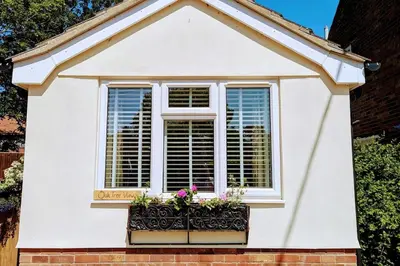 a window with flowers in a window box at Oak Tree View - relax, reconnect, explore or work in East Harling