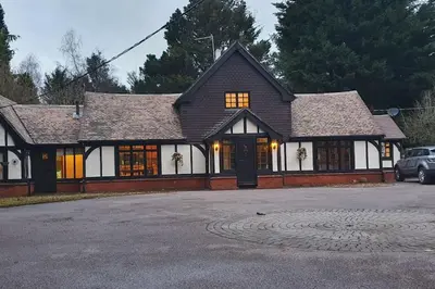 a house with a car parked in front of it at Beautiful cottage in Brentwood in Kelvedon Hatch