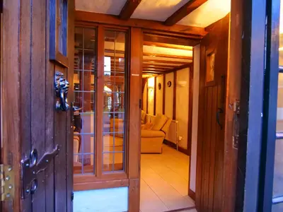 a hallway with glass doors and a living room at Beautiful cottage in Brentwood in Kelvedon Hatch