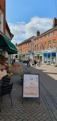 a sign on a street in a city with buildings at Shoemakers Cottage, Halesworth in Halesworth