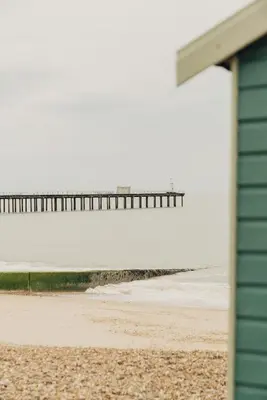 a view of the beach with a pier in the background at Pier View Felixstowe - Sea View, 50m from the beach in Felixstowe