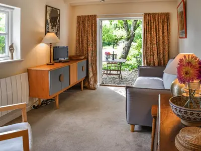 a living room with a couch and a table at Little House On The Common in Wortham