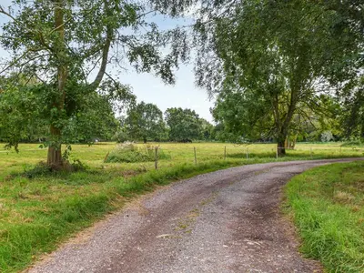a dirt road in the middle of a field at Little House On The Common in Wortham