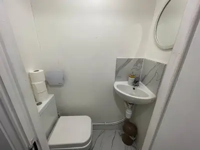 a white bathroom with a toilet and a sink at Luxurious 2 bed home in Basildon in Basildon
