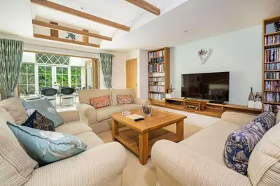 a living room with two couches and a tv at The Granary at Pannels Ash Farm in Sudbury