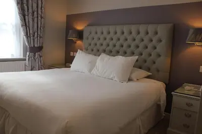 a bedroom with a large white bed and a window at Centennial Hotel in Cambridge