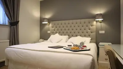 a hotel room with a bed with a tray of food on it at Centennial Hotel in Cambridge