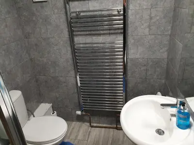 a bathroom with a white toilet and a sink at Studios in Ely