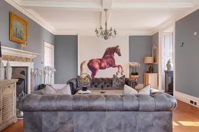 a living room with a couch with a horse statue on the wall at Darcy West in Colchester