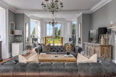 a living room with a couch and a table at Darcy West in Colchester