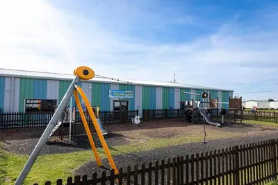 a playground with a slide in front of a building at 2br-sleeps6-wifi-freeparking-holidaypark in Clacton-on-Sea