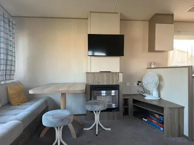 a small living room with a table and a couch at 2br-sleeps6-wifi-freeparking-holidaypark in Clacton-on-Sea