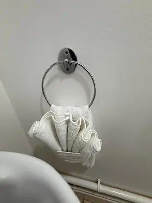 a towel holder on a wall next to a toilet at Contractor, families and bikes in Earith