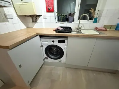 a kitchen with a washing machine and a sink at Contractor, families and bikes in Earith