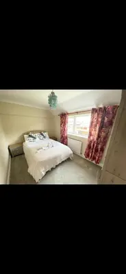 a bedroom with two beds and a window at Contractor, families and bikes in Earith