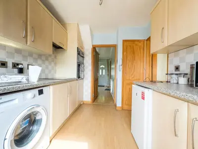 a kitchen with a washer and dryer at Morden holiday in Basildon