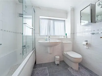a bathroom with a sink and a toilet and a shower at Morden holiday in Basildon
