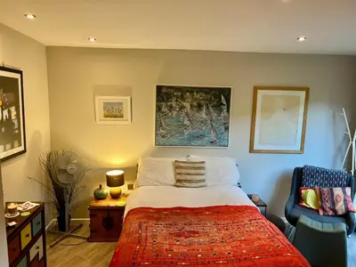 a bedroom with a bed and a chair at Modern, Gr Floor 1 bed, bathroom, garden & private entry with Free Parking in Cambridge