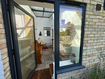 a glass door to a house with a patio at Beautiful Victorian house in central Cambridge in Cambridge
