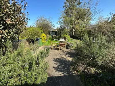 a view of a garden with a table and chairs at Beautiful Victorian house in central Cambridge in Cambridge