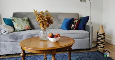 a living room with a couch and a table with a bowl of apples at R&O Property Experts - Riverside - 2 & 3 BR - Flat Walk to Centre with open Parking in Cambridge