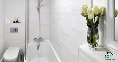 a vase of flowers sitting on a counter in a bathroom at R&O Property Experts - Riverside - 2 & 3 BR - Flat Walk to Centre with open Parking in Cambridge
