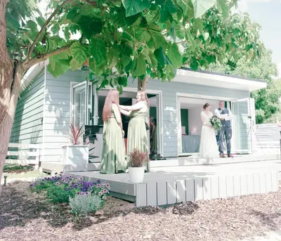 a bride and groom standing on the porch of a house at The Hideaway-Perfect Staycation in Belchamp Saint Paul