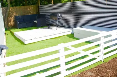 a white fence with a bench and a chair at The Hideaway-Perfect Staycation in Belchamp Saint Paul