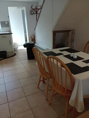 a kitchen with a table and chairs in a room at Bellevue cottage in Wicken