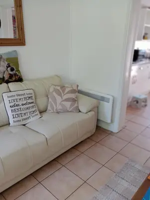 a white couch sitting in a living room at Bellevue cottage in Wicken