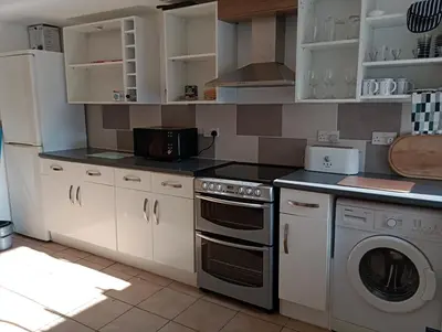 a kitchen with a stove and a dishwasher at Bellevue cottage in Wicken
