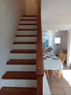 a staircase leading up to a living room and a dining room at Bellevue cottage in Wicken