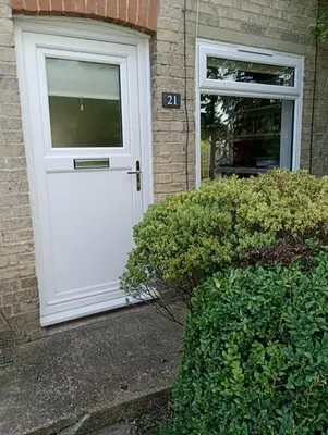 a white door on a house with a window at Bellevue cottage in Wicken