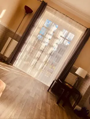 a living room with a large window and a chair at AC Lounge 36 (Room D) in Rochford