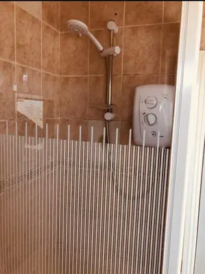 a shower with a shower head in a bathroom at AC Lounge 36 (Room D) in Rochford