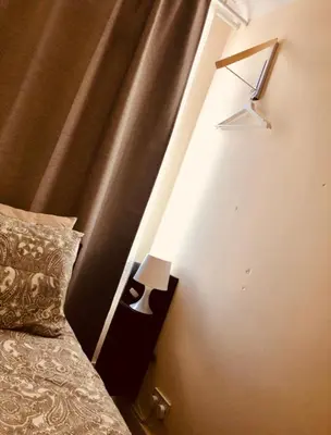 a bedroom with a bed with a light on the wall at AC Lounge 36 (Room D) in Rochford