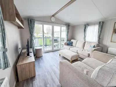 a living room with two couches and a tv at Modern 8 Berth Caravan With Decking At Naze Marine Park, Essex Ref 17145P in Walton-on-the-Naze