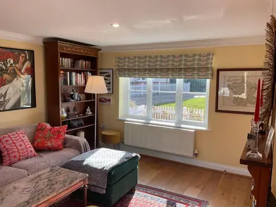 a living room with a couch and a window at Peaceful house ideal for dogs lovely location in Aldeburgh