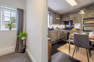 a kitchen with a table and a dining room at Crown Street 4 in Bury Saint Edmunds