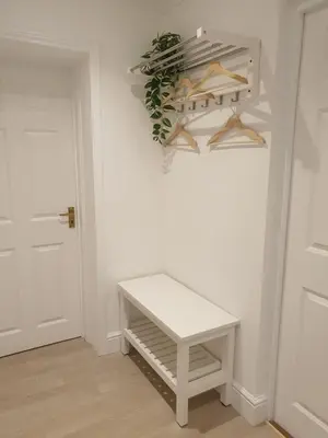 a white room with a bench and a door at Fly By - Duxford close to IWM & Wellcome Genome Campus in Duxford